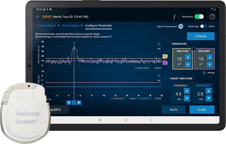 Medtronic Inceptiv generator beside a clinician tablet showing a demonstration programming screen